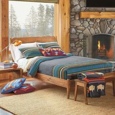 a bed sitting next to a fire place in a bedroom