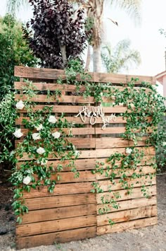 a wooden fence with vines and flowers growing on it that says welcome to the bride