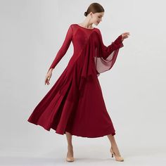 a woman in a red dress is dancing