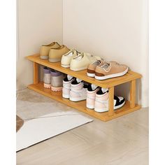 several pairs of shoes are lined up on a wooden shelf in front of a door