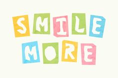 the words smile more written in multicolored paper