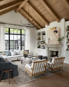 a living room filled with furniture and a fire place in the middle of a room