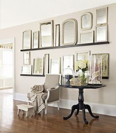 a living room filled with furniture and pictures on the wall