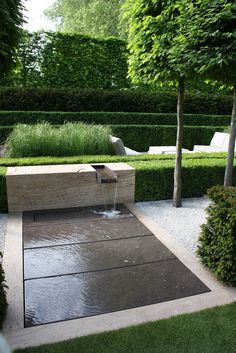 a water feature in the middle of a garden