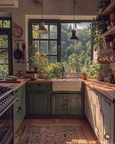 a kitchen filled with lots of green cupboards and counter top space next to a window