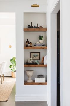 an open book shelf in the middle of a dining room