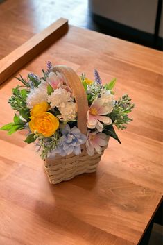 A mix of beautiful soft pink/yellow, baby blue and white flowers in a small basket. Contains baby blue camellias, pink daisies, yellow rununculus, and white dahlias, white/green dusty miller greenery. A perfect basket for get well soon gifts. Hydrangea Daisy Bouquet, Light Blue And Yellow Flower Arrangements, Basket Of Daisies, Basket With Wild Flowers, Wildflower Basket Arrangement, Basket Bouquet, Summer Basket, Chamomile Flower, Blue And White Flowers