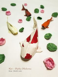 origami koi fish and flowers on white surface