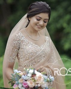 a woman in a wedding dress holding a bouquet