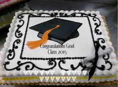 a graduation cake decorated with an orange tassel and the words congratulations's grad