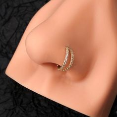 a close up of a ring on a mannequin's torso with black background