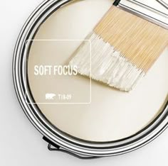 a paint brush is on top of a tin with the word soft focus below it