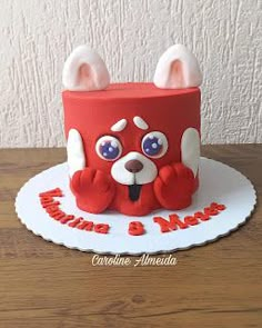 a red cake with white ears and blue eyes