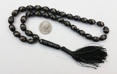 "For sale is an Authentic Antique Yemeni Black Coral Islamic 33 Prayer/Worry Beads Necklace. Necklace has 36 beads total, 33 beads are old and rare black coral oval beads with silver inlaid nails in a chevron shaped band and inlaid silver rings, 2 beads are small black coral disc beads and the other is the large cylindrical pendant bead. Most of the beads are in excellent condition, some of the beads may have some light wear/scratches/small chipping and missing silver inlays characteristic of th Traditional Black Rosary With 8mm Beads, Artisan Black Beads 8mm, Artisan Black 8mm Beads, Black Oval Bohemian Beads, Black Oval Beads Artisan Style, Traditional Black Necklace With Oval Beads, Traditional Black Jewelry With Oval Beads, Artisan Black Oval Beads, Black Polished Artisan Beads