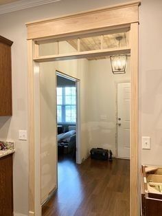 an open door leading to a bedroom and kitchen