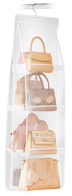 three clear bags hanging on the wall with purses and handbags in front of them