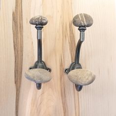 two stone knobs mounted to the side of a wooden wall