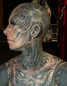 a man with tattoos on his body and chest