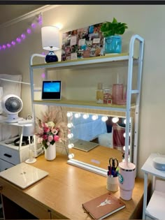 a desk with a laptop and some lights on it