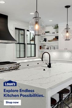 a kitchen with white cabinets and marble counter tops, hanging lights over the stove top