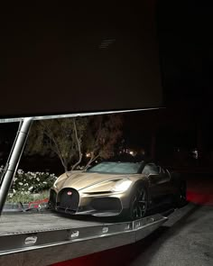 a bugatti car is parked on the street at night