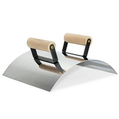 a pair of knives sitting on top of a metal object with wooden handles and black handles