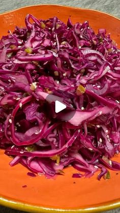 an orange plate topped with red cabbage and onions