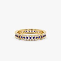 a yellow gold ring with blue and white stones