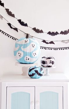 a white cabinet topped with lots of halloween decorations