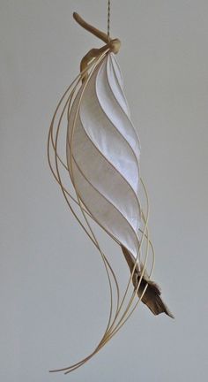 a white feather hanging from a string