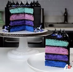 two pieces of cake are sitting on the plates in front of each other, one is blue and one is pink