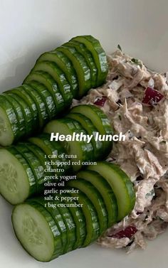 cucumber slices and tuna salad in a white bowl with the words healthy lunch