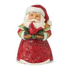 a santa clause figurine holding a red bird