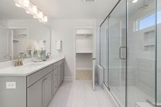 a large bathroom with two sinks and a walk in shower