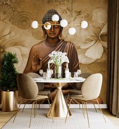 a buddha statue sitting on top of a table in front of a wall with flowers