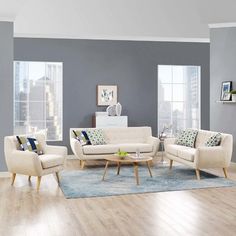 a living room with two couches, chairs and a coffee table in front of a window