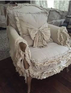 an old chair is covered with ruffled fabric