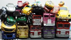 a bunch of toy cars that are stacked on top of each other in different colors