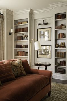 a living room filled with furniture and bookshelves