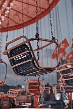 an empty basket hanging from a carousel at night