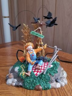 a statue of a scarecrow sitting on top of a table