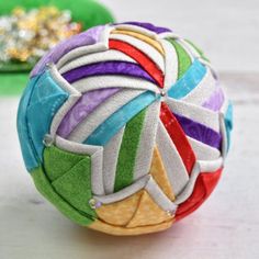 a multicolored ball sitting on top of a table