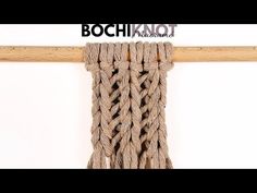 a close up of a rope hanging on a wooden pole with the word bochiknot above it