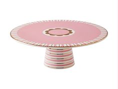 a pink and white cake plate with a flower on it