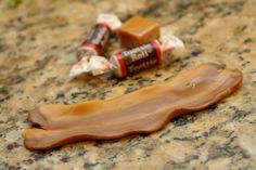 two chocolate bars sitting on top of a counter next to some candy bar wrappers