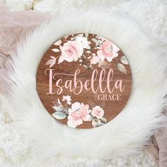 a personalized wooden sign with pink flowers on it