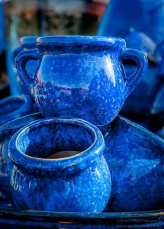 blue pottery is stacked on top of each other