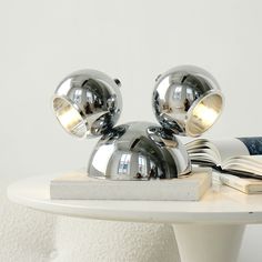 The Mickey Table Lamp is an eye-catching home decor choice. With its iconic silhouette decorating the lampshade, it adds an element of fun and classic style to any room. Enjoy a great lighting solution with the Mickey Table Lamp. If you have any questions about our products, please contact us and we will get back to you within 24 hours. Product Size Size: Dia 25cm x H 15cm / ∅ 9.8″ x H 5.9″ Details Materials: Metal, Iron Light source: LED bulb or Edison bulb Light source base type: G4 Voltage: A Lift Design, Bulb Light, Iron Lighting, Dream Vacation, Edison Bulb, Desk Lamps, Edison Light Bulbs, Lighting Solutions, Led Lamp