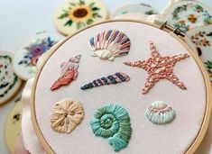 there are many seashells on the embroidery