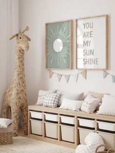 a room with two giraffes hanging on the wall and some storage bins